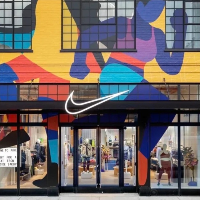 A Nike store front beneath a large colourful mural