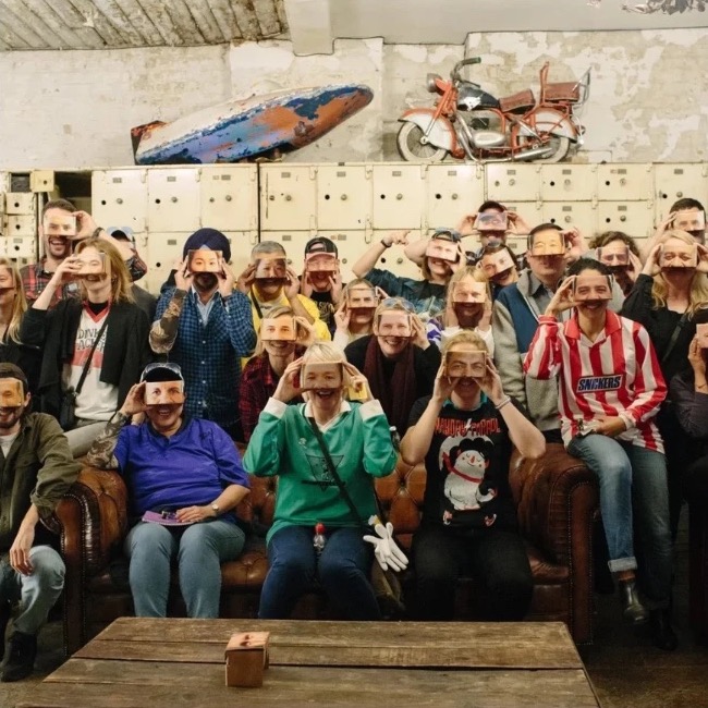 Shell workshop participants holding up photographs of truck drivers’ eyes in front of their faces